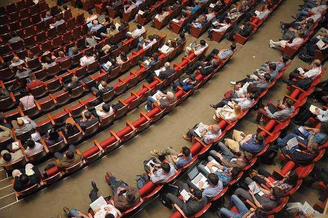 a group of students listening to a lecture about how to teach someone how to speak english
