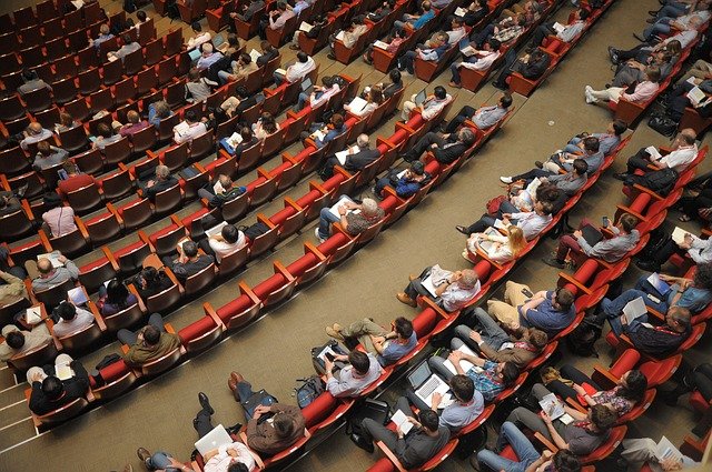 a group of students listening to a lecture about how to teach someone how to speak english