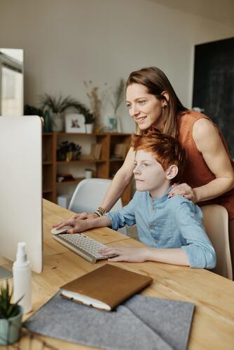 A mother helping her child learn on the computer