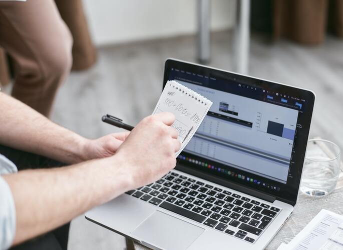 A man checking things in front of a laptop