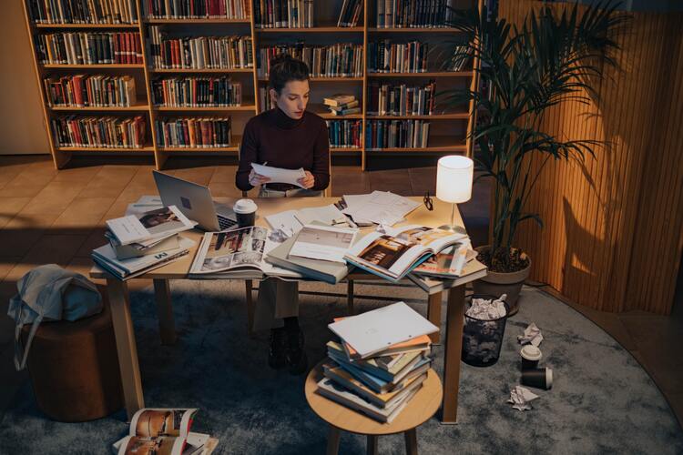 A woman planning with notes and books