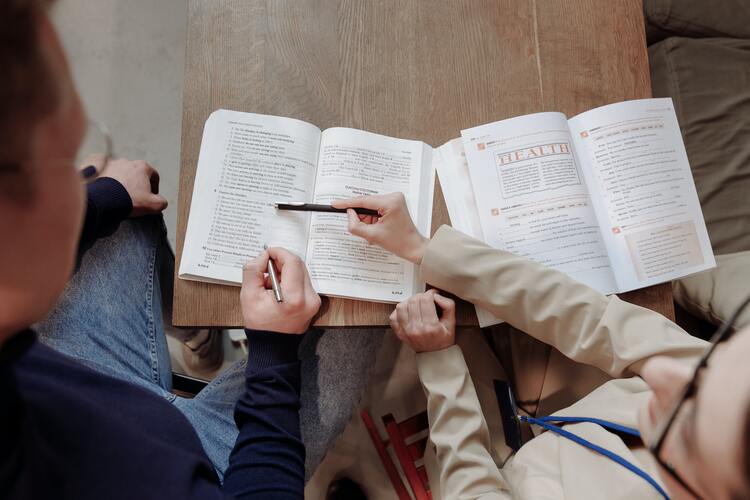 A person pointing out a part in a book