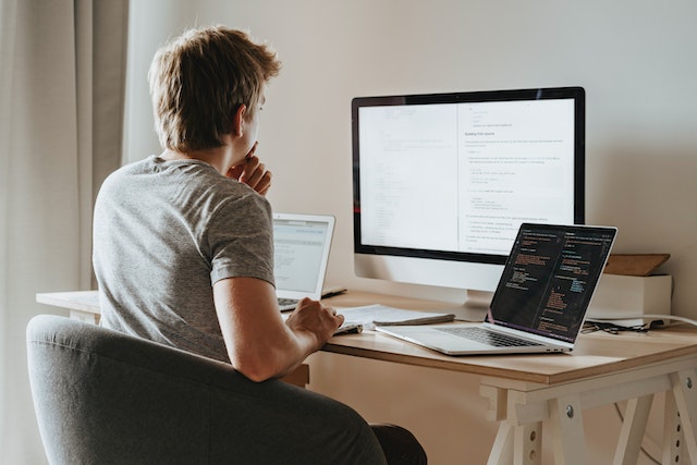 A person sitting in front of a laptop