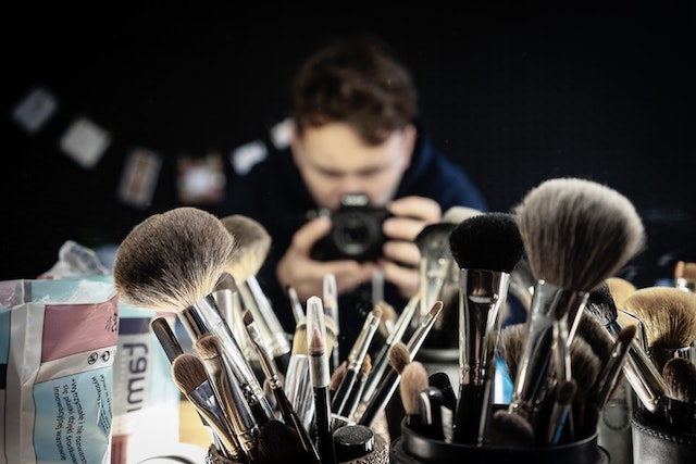 A person photographing a make-up set