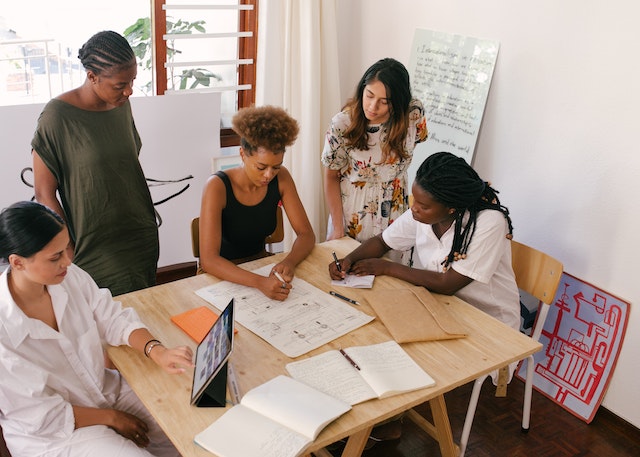 A team meeting where people are looking at a doc