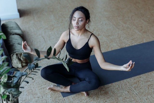 Woman meditating on yoga mat