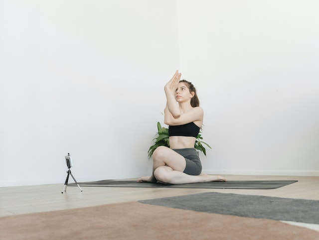 a woman teaching yoga online