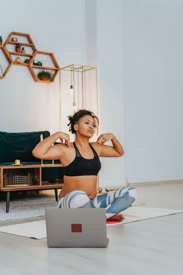 Woman taking yoga classes online