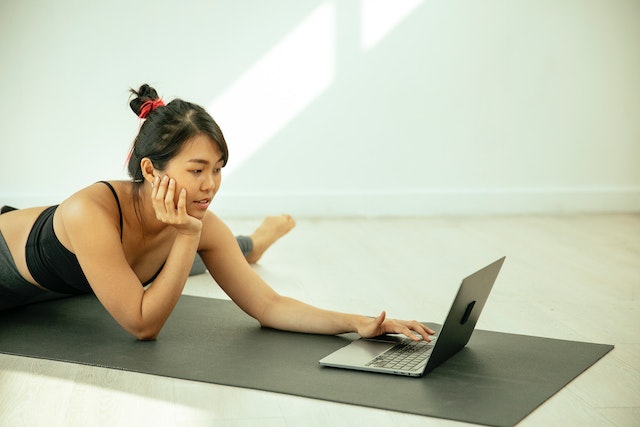 a woman teaching yoga online