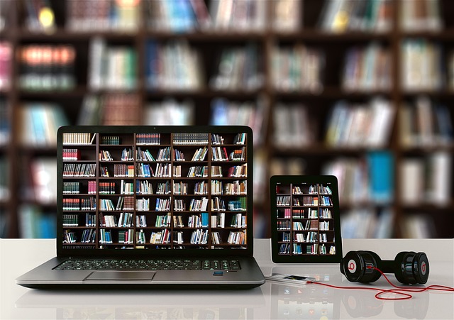 Laptop, tablet and a earphone kept on a desk at a library