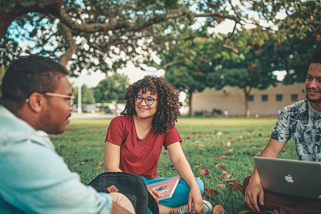 Three people discussing something in a garden