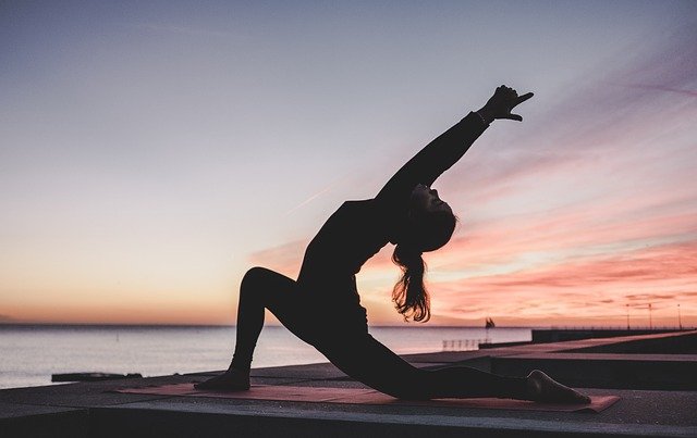 a woman doing yoga outdoors