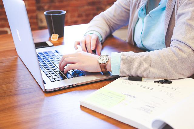 A person typing on the laptop