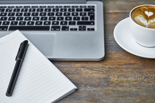 A computer with coffee beside it