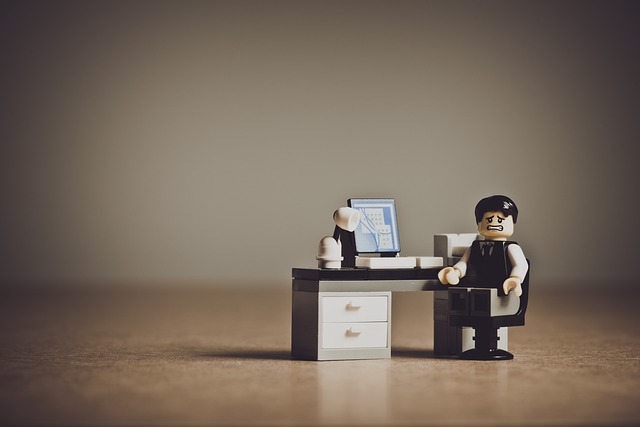 a lego doll sitting thinking about a problem in online course