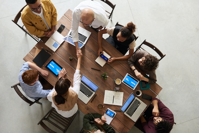 a group of people discussing technology together