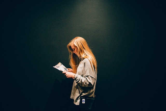 A woman reading on a black background