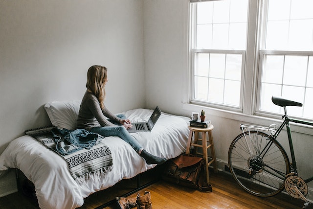 A woman learning from their bedroom