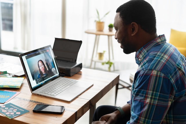 Person smiling while learning on laptop