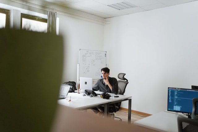 a person in a office watching a webinar