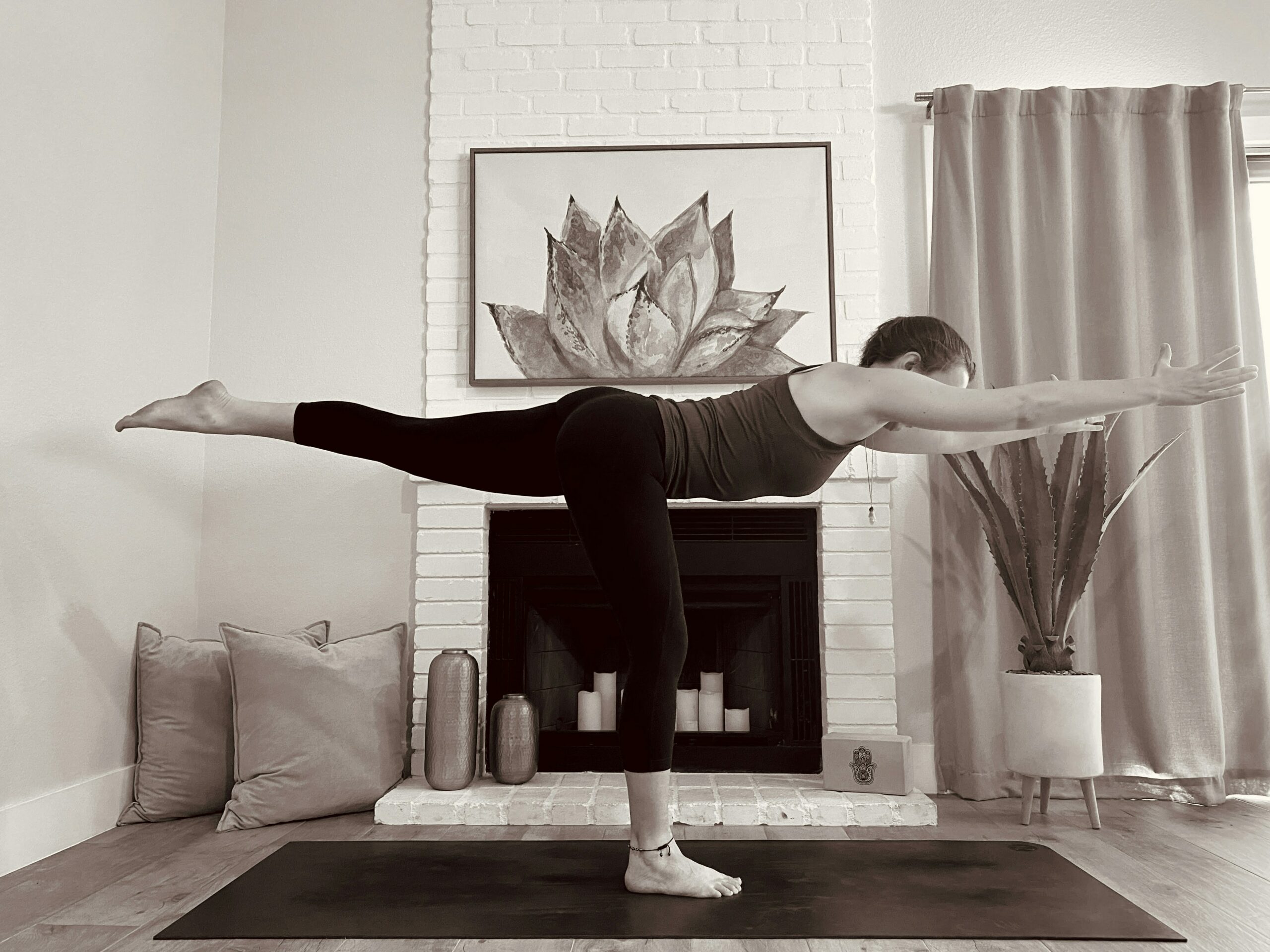 doing a yoga pose as shown in an lms for yoga school
